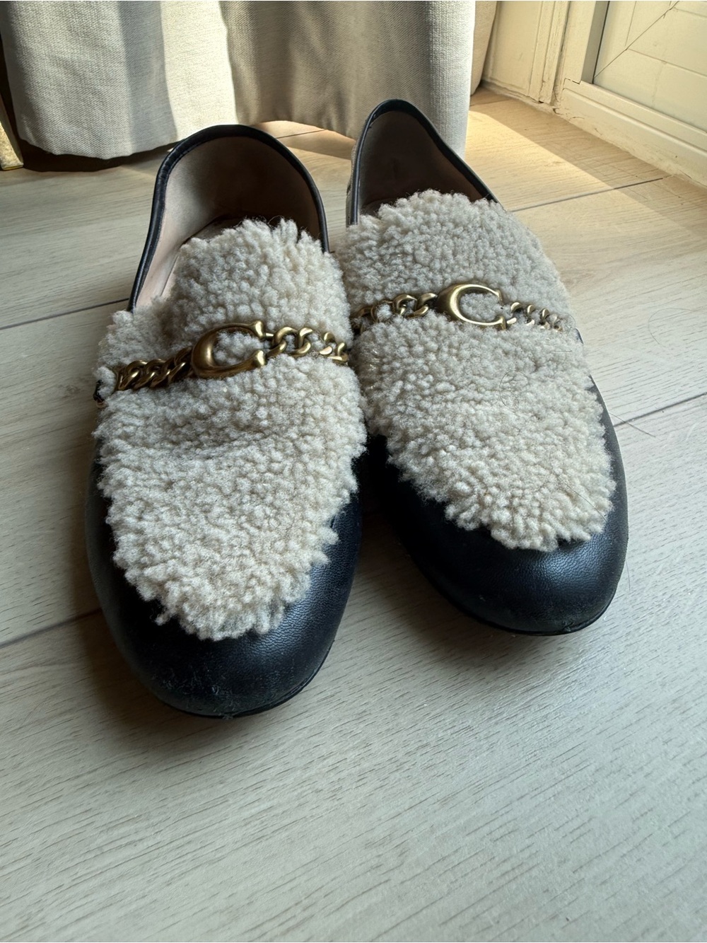 Coach Black Loafers with Cream Shearling and Gold Chain
